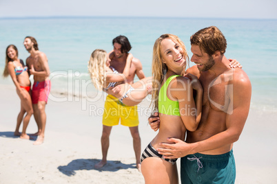 Smiling young couple embracing at beach