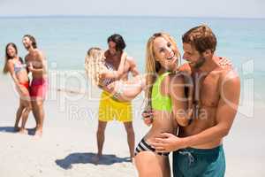 Smiling young couple embracing at beach