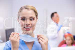 Portrait of happy nurse wearing surgical mask