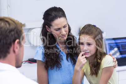 Young patient showing teeth to dentist