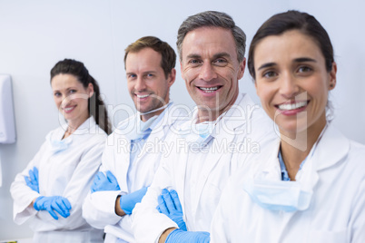 Smiling dentists standing with arms crossed