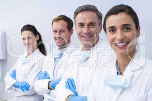 Smiling dentists standing with arms crossed