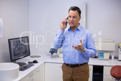 Dentist talking on mobile phone