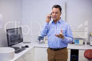 Dentist talking on mobile phone
