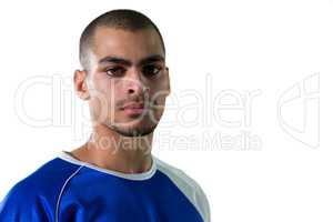 Portrait of football player standing against white background