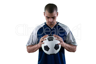 Football player holding football with both hands