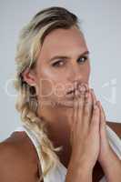 Portrait of transgender woman with hands clasped