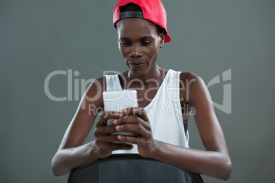 Androgynous man using mobile phone