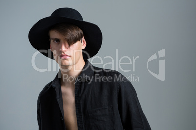 Androgynous man in hat posing