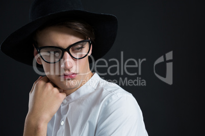 Androgynous man posing with hand on his cheek