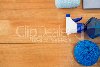 Overhead view of blue spray bottle and sponge