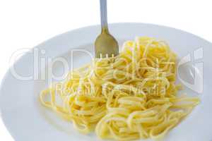 Close-up of spaghetti in plate with fork
