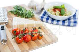 close up of cheese and tomatoes on cutting board