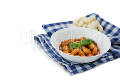 High angle view of gnocchi pasta in bowl on napkin