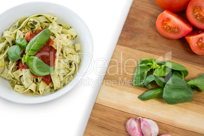 Close up of vegetables on cutting board by pasta