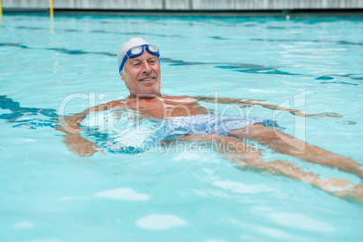 Senior man swimming in pool