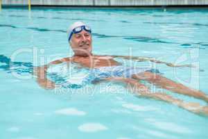 Senior man swimming in pool