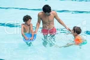 Father interacting with kids in the pool