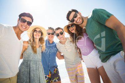 Young friends standing against sky