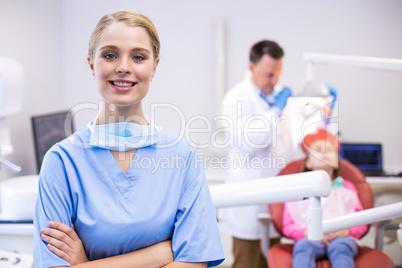 Portrait of smiling nurse with arms crossed