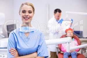 Portrait of smiling nurse with arms crossed