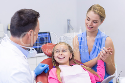 Dentist interacting with young patient