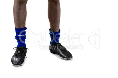 Low section of football player with football boots and socks