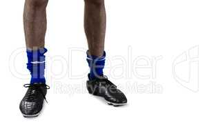 Low section of football player with football boots and socks