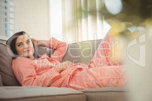 Beatiful woman in night suit lying on sofa