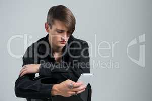 Androgynous man using mobile phone