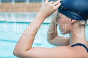 Fit woman wearing swimming goggle in pool