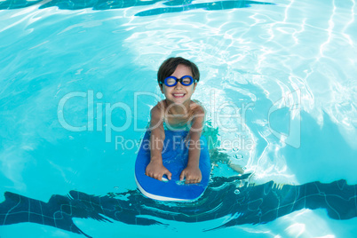 Smiling boy swimming in the pool