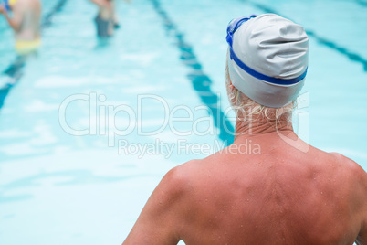 Senior man sitting at poolside