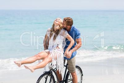 Young couple on bicycle at beach