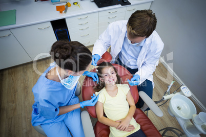 Dentists examining a young patient