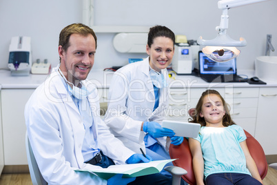 Portrait of smiling dentists and young patient