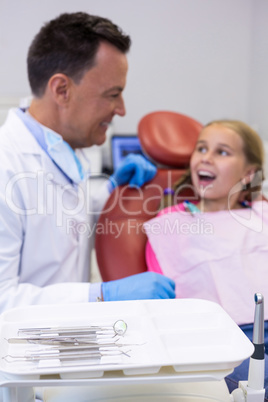 Dentist interacting with young patient