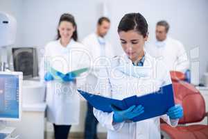 Dentist looking at reports in dental clinic