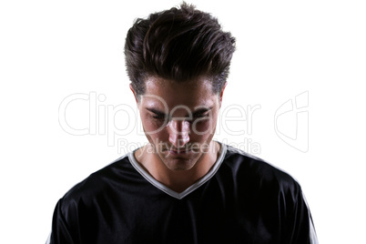 Upset football player looking down
