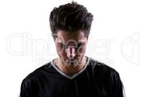 Upset football player looking down