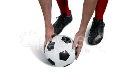 Football player placing football