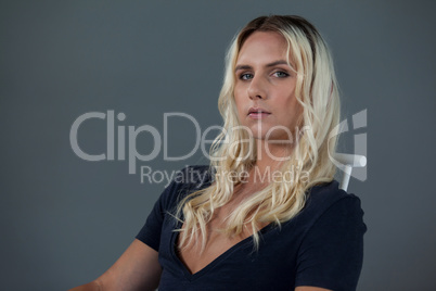 Portrait of beautiful transgender woman sitting on chair