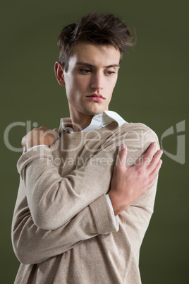 Androgynous man touching his body