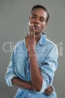 Androgynous man posing with cigarette