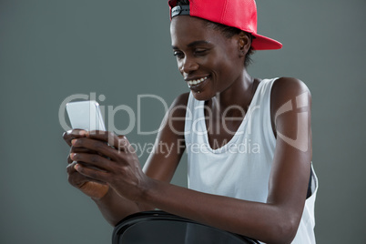 Androgynous man using mobile phone