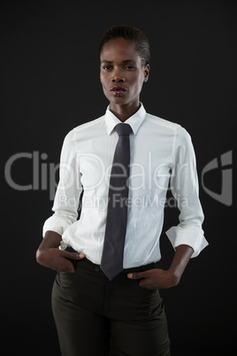 Androgynous man standing with his hands in pocket