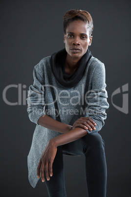 Androgynous man posing against grey background