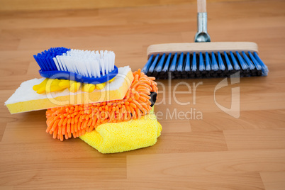 Close-up of sponges and brush by broom