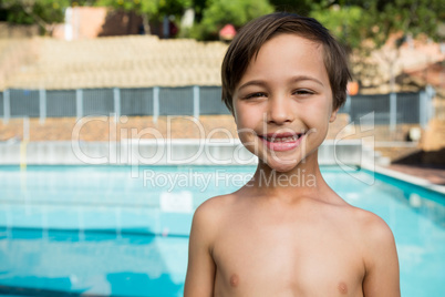 Smiling boy standing near poolside Smiling boy standing near poolside