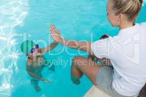 Female trainer giving high five to boy